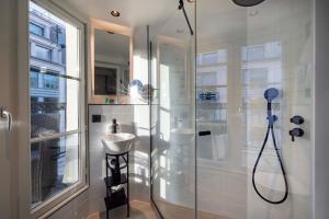 a bathroom with a shower and a sink at Le 12 Hôtel in Paris