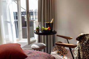 a room with a table with a candle and a window at Le 12 Hôtel in Paris