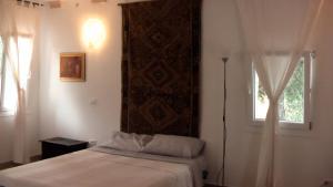 מיטה או מיטות בחדר ב-Dipendanza Veneri