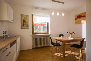 a kitchen with a table and chairs and a window at Ferienwohnung Strohmeyer in Oberaudorf
