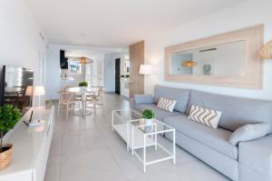 a living room with a blue couch and a table at AG SAN PAULO PREMIUM in Playa de Gandia