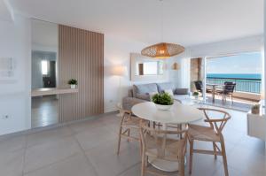 a living room and dining room with a table and chairs at AG SAN PAULO PREMIUM in Playa de Gandia