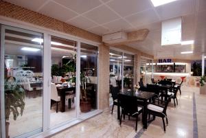 a restaurant with tables and chairs and a bar at Lara Diamond Hotel in Antalya