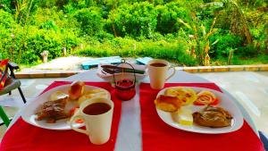 a table with two plates of food and two cups of coffee at Eco Domo glamping in Armenia