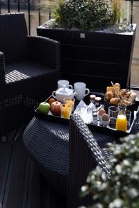 a table with a tray of breakfast food on it at Le 12 Hôtel in Paris