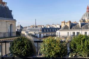 a view of a city with buildings and roofs at Le 12 Hôtel in Paris
