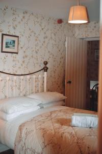 
a bedroom with a bed and a lamp at Basil Sheils B&B Accommodation Armagh in Armagh
