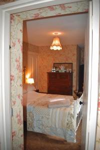 
a bedroom with a bed and a mirror at Basil Sheils B&B Accommodation Armagh in Armagh
