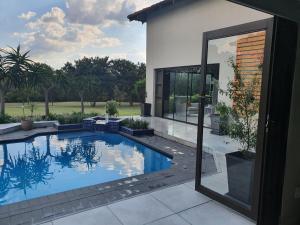 a swimming pool in the backyard of a house at Luxury Boutique Home in Kyalami in Midrand