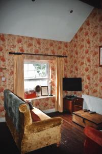 a living room with a couch and a window at Basil Sheils B&B Accommodation Armagh in Armagh