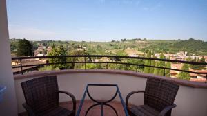 a balcony with two chairs and a view of a city at Antella Residence in Bagno a Ripoli