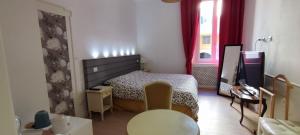 a bedroom with a bed and a desk and a television at Strada Maggiore 37 in Bologna