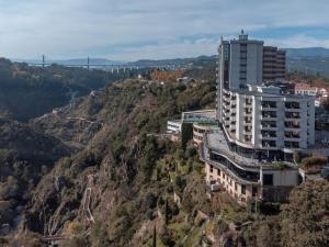 a large building with a view of mountains at Hotel Miracorgo in Vila Real