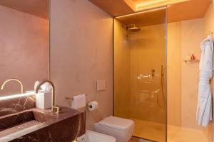 a bathroom with a toilet and a glass shower at Ca'di Dio-Small Luxury Hotel in Venice