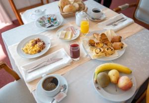 a table with breakfast foods and coffee on it at Hotel Miracorgo in Vila Real