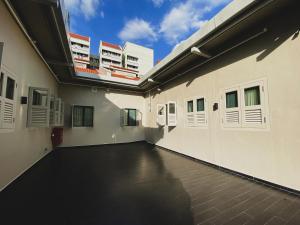 an empty corridor of a building with white doors at ST Signature Jalan Besar, DAYUSE, 5 Hours, 10AM-3PM in Singapore