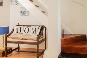 a hallway with a chair with a home sign on it at 1844 Seascape Cottage in Fanore