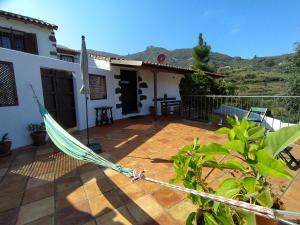 a hammock on the patio of a house at La Bohemia Apartments in Teror