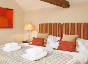 a bedroom with a bed with towels on it at The Old Kiln House in Shipston on Stour