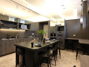 a large kitchen with a table and chairs in it at ST Signature Jalan Besar, DAYUSE, 7 Hours, 9AM-4PM in Singapore