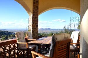 a table and chairs on a balcony with a view at Casa Mas Tomasi in Pals