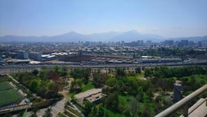 une vue aérienne d'une ville avec des bâtiments et une autoroute dans l'établissement Frente al parque (Solo mujeres), à Santiago