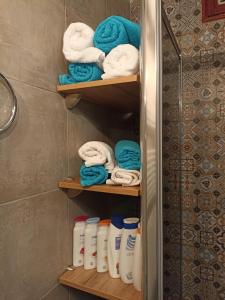 a towel rack with towels in a bathroom at Apartment Close2park *** in Čakovec