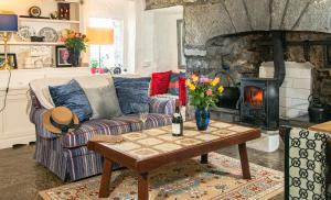 a living room with a couch and a fireplace at 1844 Seascape Cottage Is located on the Wild Atlantic Way in Fanore