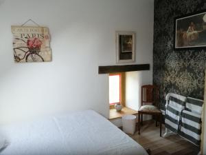 a bedroom with a bed and a window and a chair at Beautiful 2-Bed House in Saint-Leger-Magnazeix in Saint-Léger-Magnazeix