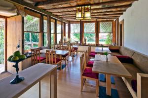 a restaurant with wooden tables and chairs and windows at Gulevi Safranbolu Heritage Hotel in Safranbolu