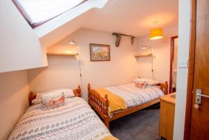 two beds in a small room with a attic at High Greenside in Kirkby Stephen