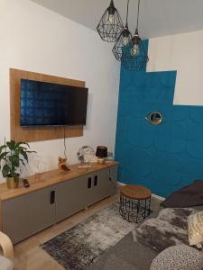 a living room with a flat screen tv on a wall at Apartment Close2park *** in Čakovec