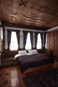 a bedroom with a large bed in a room with windows at Gulevi Safranbolu in Safranbolu