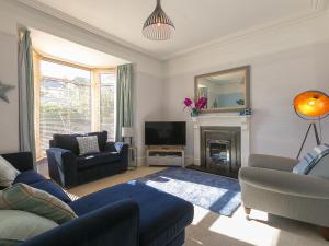 een woonkamer met een bank en een tv bij Trengoff in St Ives