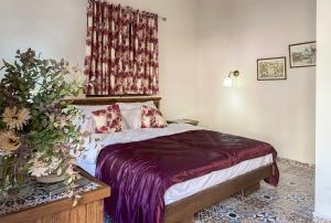 a bedroom with a bed and a window with curtains at Abu Hanna Boutique by Ahlan Hospitality in Nazareth