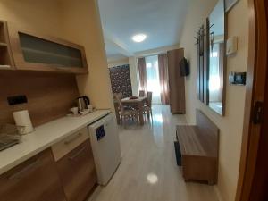 a kitchen and dining room with a table in it at Apartmani CENTAR- Smederevo in Smederevo