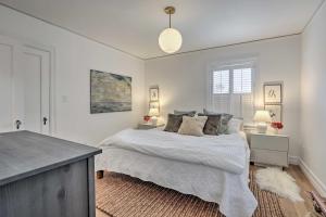 a white bedroom with a bed and a window at Reno Home Less Than 1 Mile to Midtown and Truckee River in Reno
