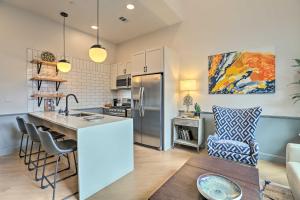 a kitchen with a kitchen island with a counter top at Modern Downtown Birmingham Condo with Rooftop Access in Birmingham
