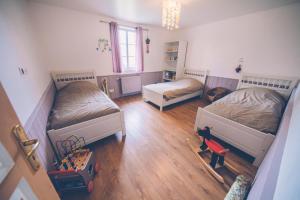 a room with two beds and a table and a chair at Fermette les Ormes, 8 personnes, Merlimont village in Merlimont