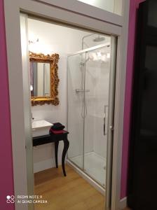 a bathroom with a glass shower and a sink at Alojamiento Buciero in Santoña +44 photos