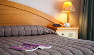 Voodi või voodid majutusasutuse Distinction Heritage Gateway Hotel toas