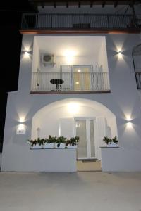 a white building with a balcony with flowers on it at FOUR WHITE APARTMENTS in Agerola