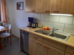 a kitchen with a sink and a bowl of fruit at Haus Böhler in Fröhnd