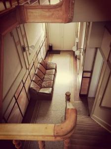 a view of a living room with a couch and stairs at karaktervolle woning met zwembad te Ronse in Ronse