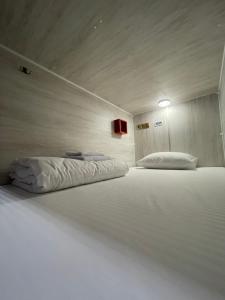 a large white bed in a room with at Хостел Baltson in Vladikavkaz