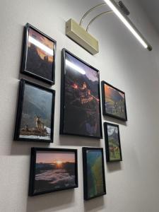 a group of pictures hanging on a wall at Хостел Baltson in Vladikavkaz