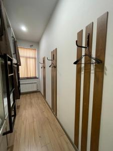 a hallway with three pivot doors on a wall at Хостел Baltson in Vladikavkaz