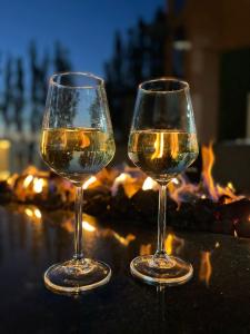 two glasses of white wine sitting next to a fireplace at The Hillcrest Hotel in Widnes