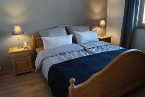 a bedroom with a large bed with blue sheets and pillows at Ferienhaus Inntal in Kiefersfelden