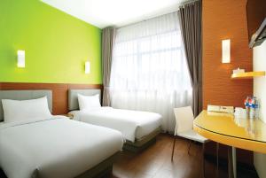 Postel nebo postele na pokoji v ubytování Amaris Hotel Samarinda